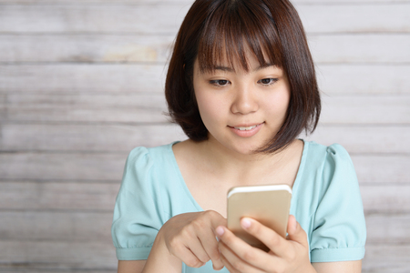 Woman looking at smart phoneの写真素材
