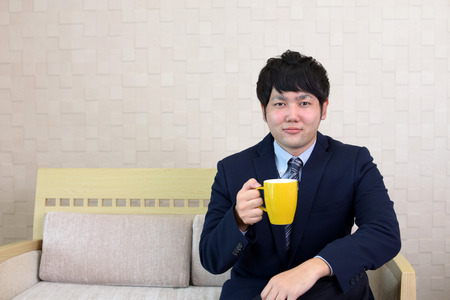 Portrait of handsome man drinking coffeeの写真素材