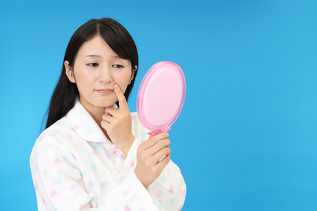 Young woman having skin problemsの写真素材