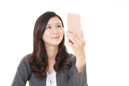 Woman looking at smart phoneの写真素材