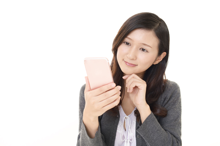 Woman looking at smart phoneの写真素材
