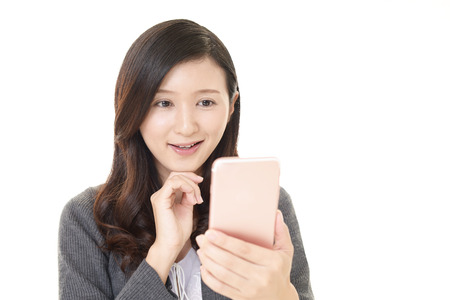 Woman looking at smart phoneの写真素材