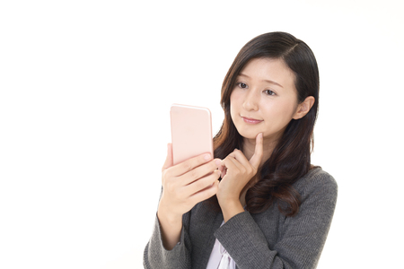 Woman looking at smart phoneの写真素材