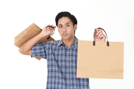 Man holding shopping bagsの写真素材