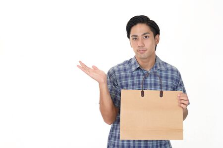 Man holding a shopping bagの写真素材