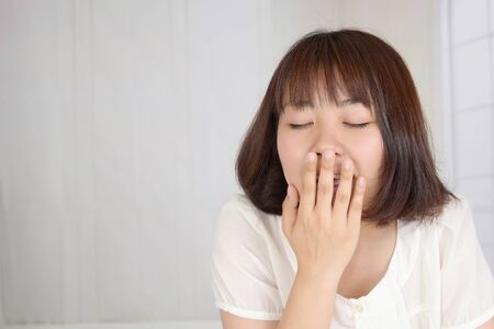 Sleepy woman yawningの写真素材