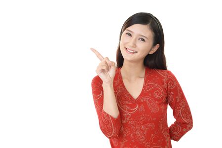Asian young woman pointing with her fingerの写真素材