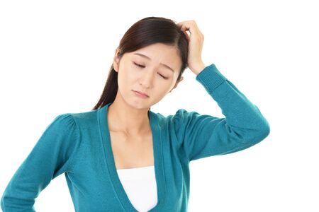 Woman looking thoughtful about troublesの写真素材