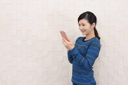 Woman looking at smart phoneの写真素材