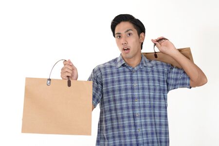 Man holding shopping bagsの写真素材