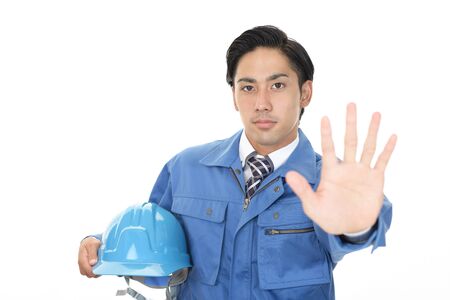 Asian worker making stop signの写真素材