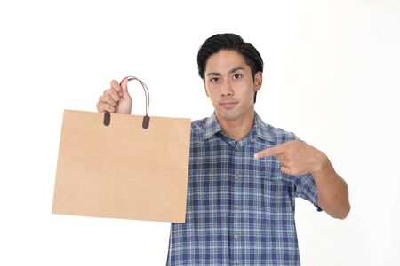 Man holding a shopping bagの写真素材