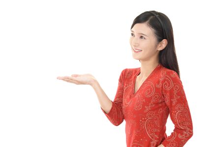 Asian young woman showing something on the palm of her handの写真素材