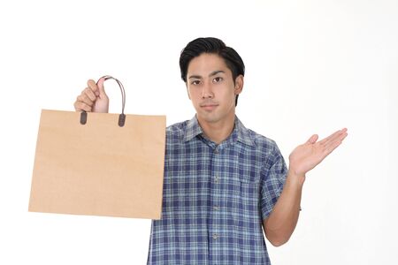 Man holding a shopping bagの写真素材