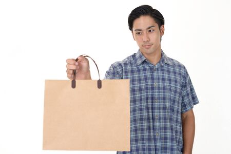 Man holding a shopping bagの写真素材