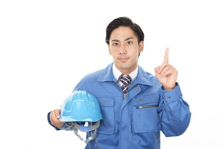 Smiling Asian man worker wearing blue uniformの写真素材
