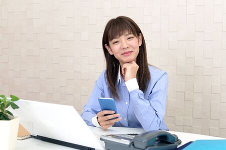 Asian business woman at her officeの写真素材