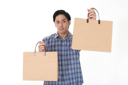 Man holding shopping bagsの写真素材