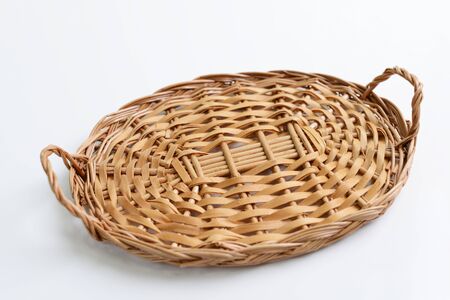 Brown wicker basket isolated over whiteの写真素材