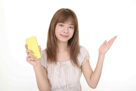 Woman holding a smart phoneの写真素材