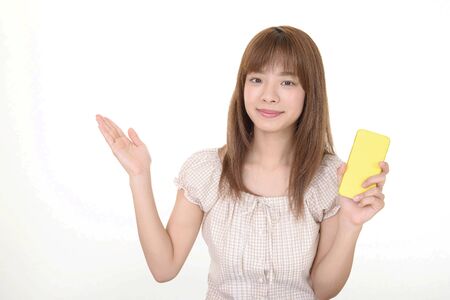 Woman holding a smart phoneの写真素材
