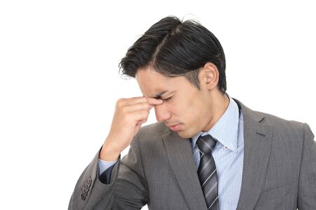Asian businessman is feeling tired and stressedの写真素材