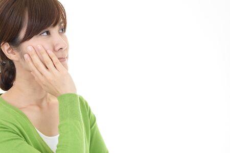 Serious Asian woman thinking about somethingの写真素材