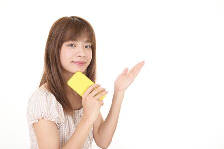 Woman holding a smart phoneの写真素材