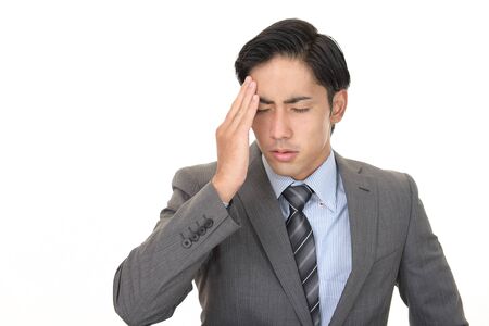Asian businessman is feeling tired and stressedの写真素材