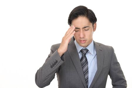 Asian businessman is feeling tired and stressedの写真素材