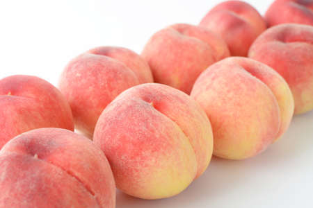 Delicious and fresh peaches on white background.の写真素材