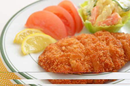 Breaded pork cutlet in a dish.の写真素材