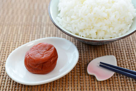 Pickled plum with a bowl of rice.の写真素材