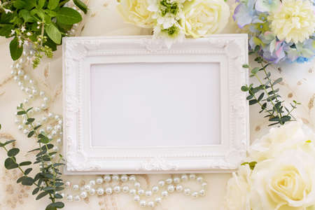 Picture frame and flowers on the table.の写真素材