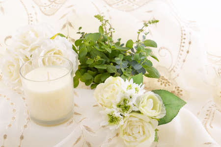 Beautiful white flowers and fragrance candle glass.の写真素材