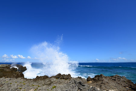 Waves breaking on the rocksの写真素材