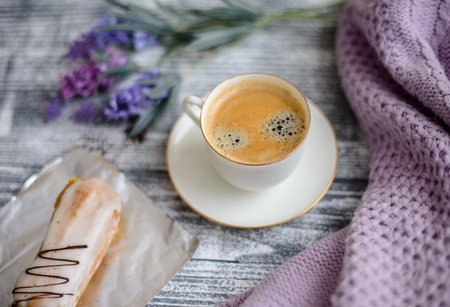 Cup of hot coffee on rustic wooden table, closeup photo warm sweater with mug, winter morning concept, top viewの写真素材