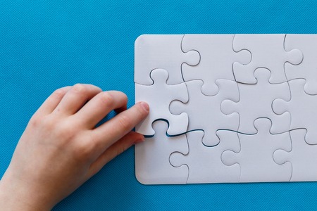 Last piece jigsaw in hand,Concept success of business.の写真素材