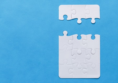 Jigsaw Puzzle with missing piece. Blue background.