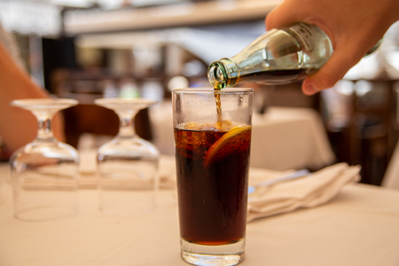 Glass of cold drink with lemon in street cafe.の写真素材