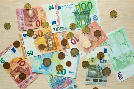 Euro bank notes and coins on the table. Top viewの写真素材