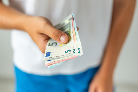 Hand holding euro banknotes. Selective focus.