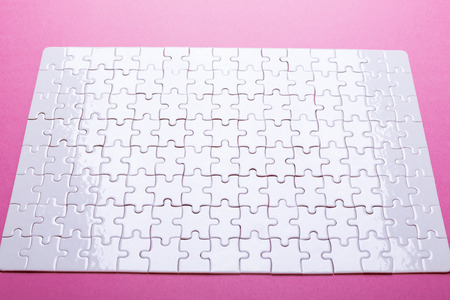 White puzzle on pink background. Missing piece. Top viewの写真素材
