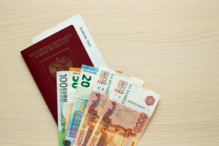 Russian passport, boarding pass and euro on table.の写真素材