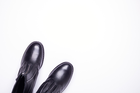 Woman accessory. Black stylish boots on white background. Top view background. Flat lay. Copy space.の写真素材