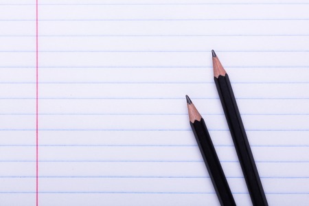 Two black graphite pencils on white sheet in line Copy space Back to school, education conceptの写真素材