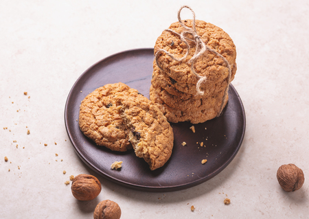 Stack of oatmeal cookies on white wooden background Homemade bakery Healthy food snack conceptの写真素材