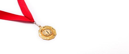 Gold medal with red ribbon on white background. Isolated. Copy spaceの写真素材