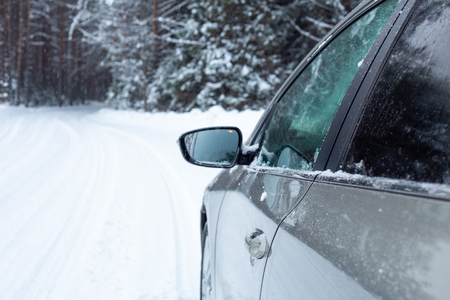 Gray car on winter road Snow forestの写真素材