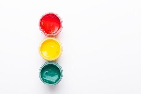 Red, yellow, green gouache on a white background Isolated Paints in containers Top view Traffic light Copy spaceの写真素材